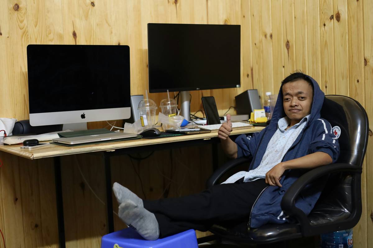 A person sitting cross-legged using their phone to access anti-stress AI tools