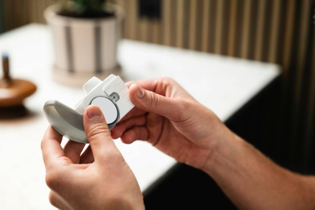 A person holding a remote control in their hand