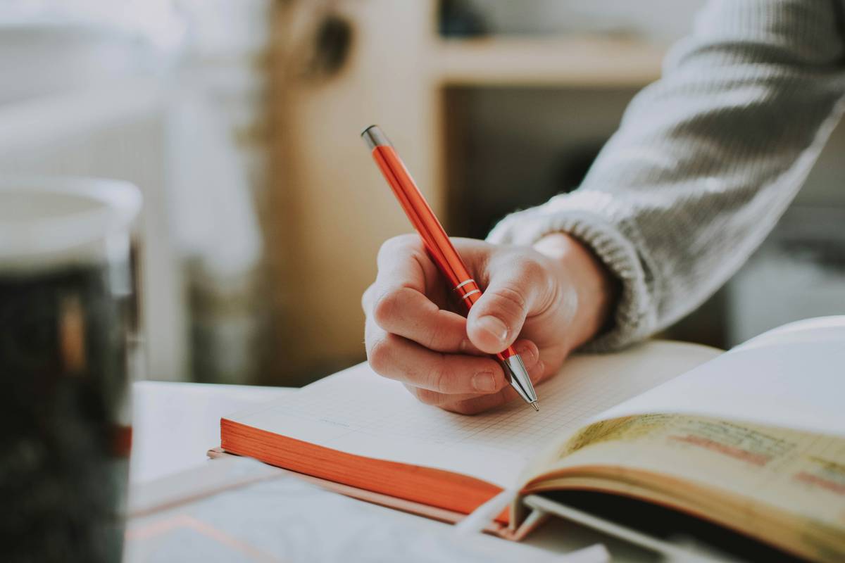 journal open on desk showing how to journal for stress relief with timed entry and physical sensation notes