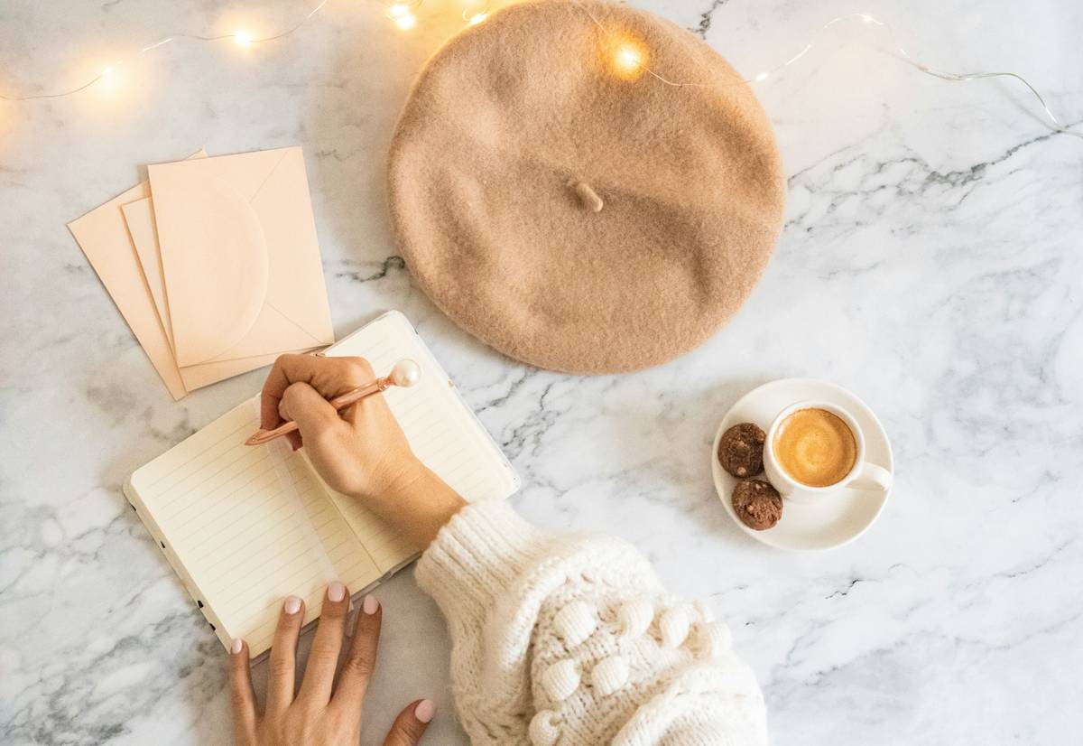 woman writing in journal for stress relief using how to journal for stress relief techniques